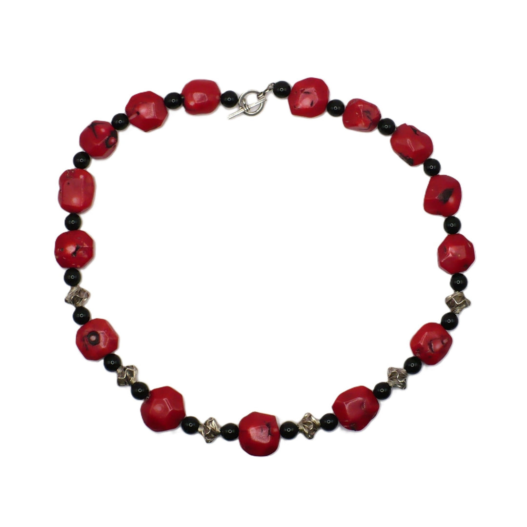 1970s vintage 26-inch chunky red bamboo coral and black onyx opera necklace with sterling silver garlic twist spacers and stationary toggle clasp.