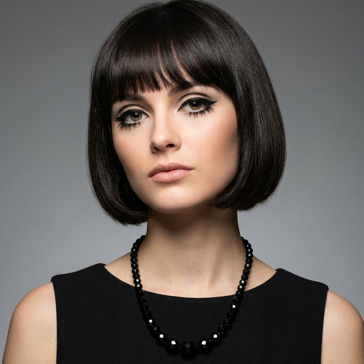 Model wearing the 1950s vintage black faceted glass beaded necklace with a black sleeveless top.