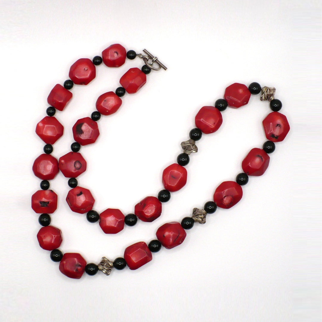 Vintage 1970s 30-inch chunky red coral and black onyx opera necklace with sterling silver accents.
