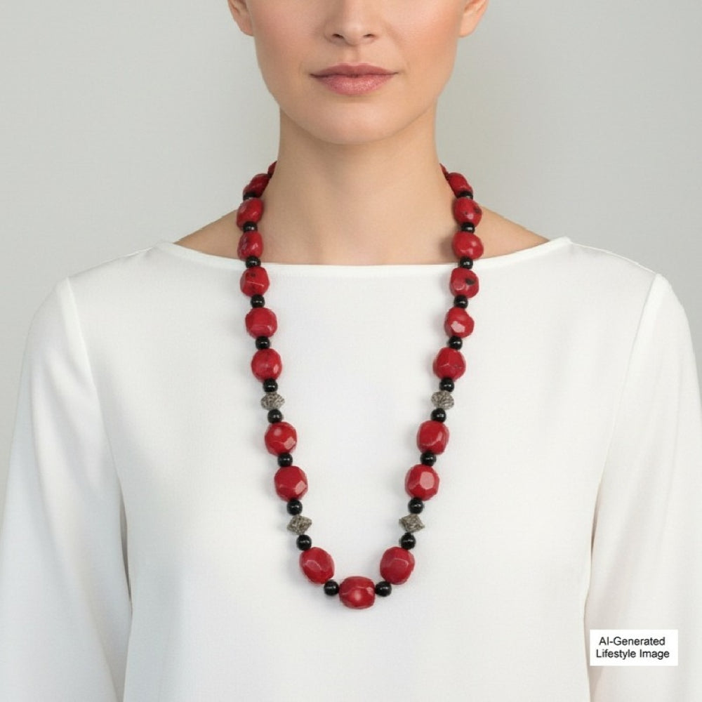 Model wearing the vintage 1970s chunky red coral and black onyx 30-inch opera necklace.