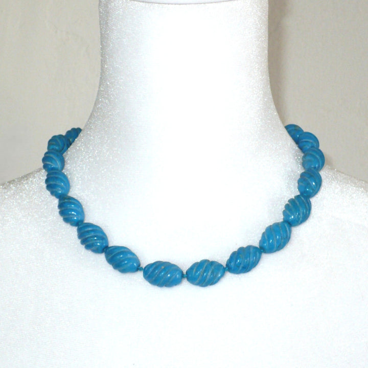 Bust display showing the 1970s vintage carved blue Howlite beaded necklace.