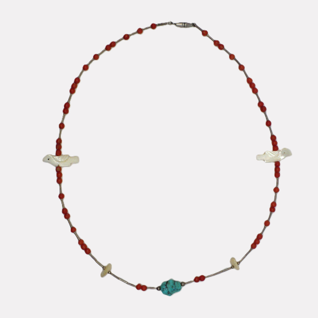 Vintage 1960s Native American Zuni hand-carved bird fetish and red coral beaded necklace shown on a white background.