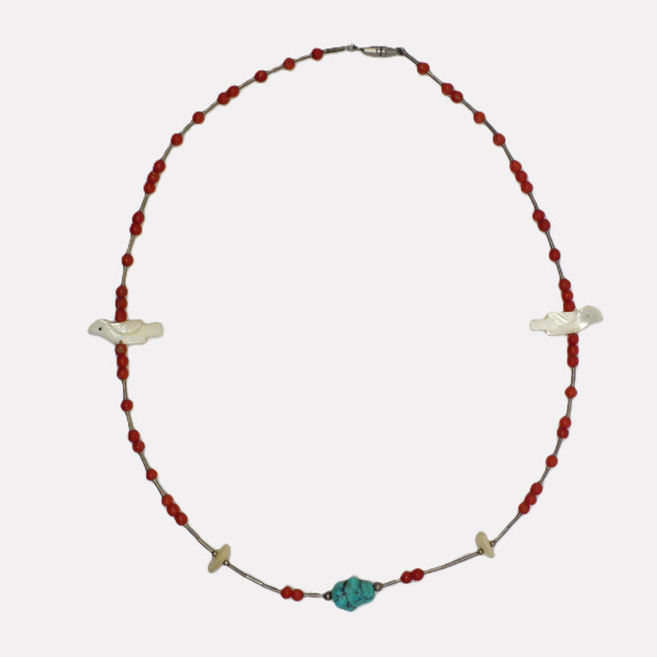 Vintage 1960s Native American Zuni hand-carved bird fetish and red coral beaded necklace shown on a white background.