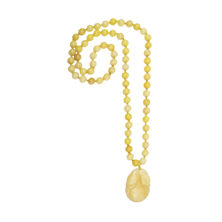 Vintage 1970s yellow nephrite jade beaded necklace with a hand-carved double-sided persimmon pendant shown against a clean white background.