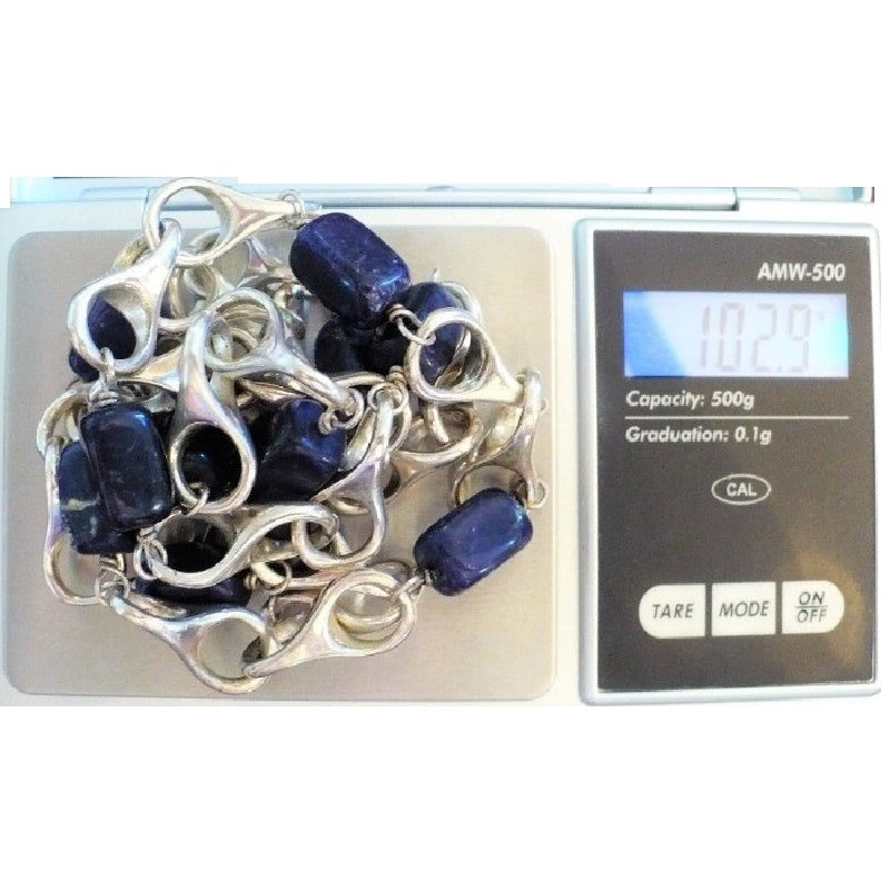 1970s vintage modernist sterling silver and blue sodalite station necklace on a digital scale weighing 102.9 grams.