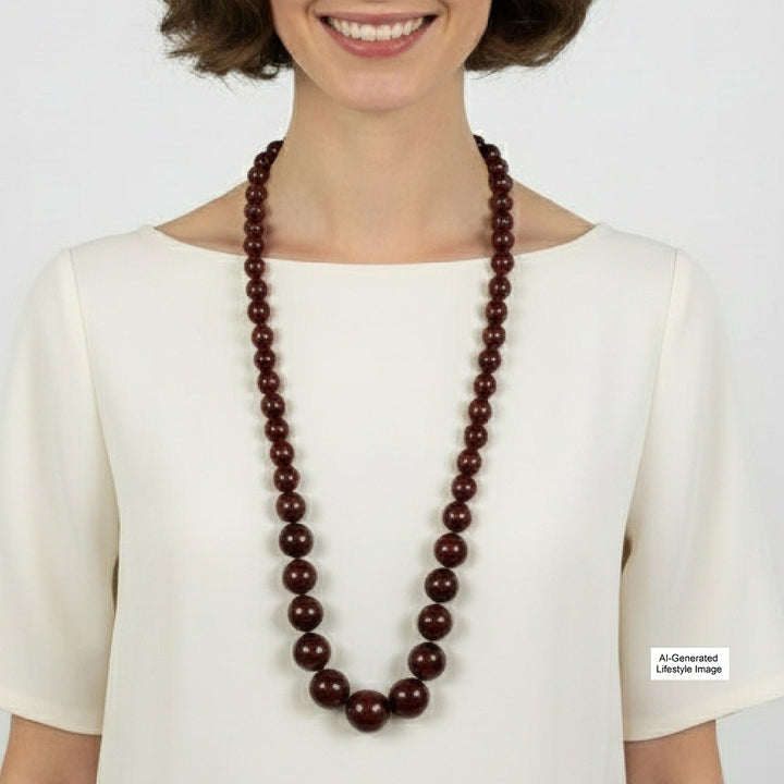 Vintage opera-length 1920s cherry amber graduated bead necklace styled on a ai-generated model.