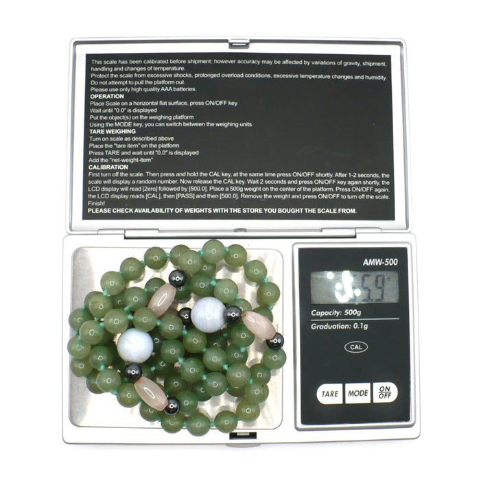 1970s Vintage Aventurine Multi-Gemstone Beaded Strand Necklace in a jewelry scale verifying weight.