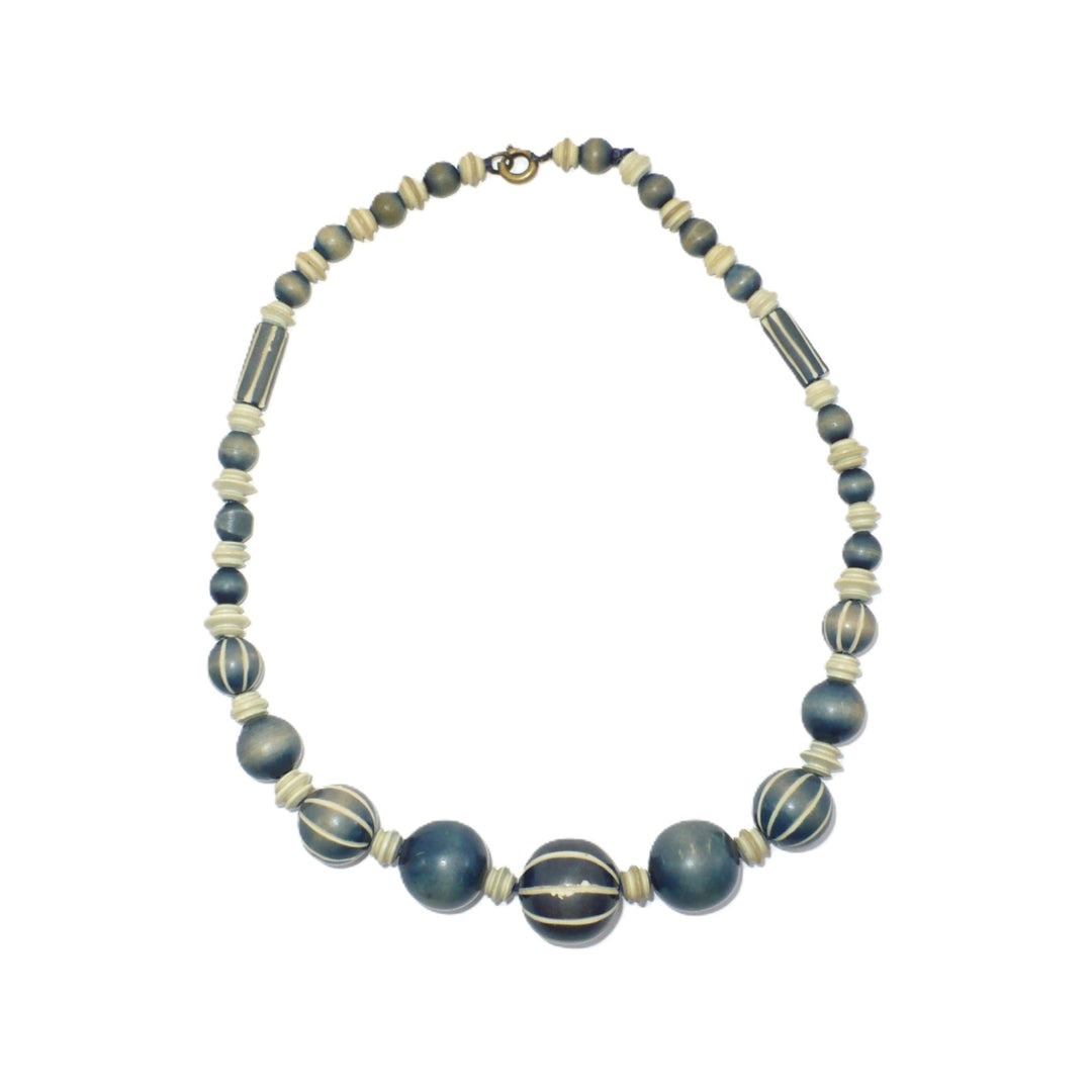 1970s vintage beaded choker necklace featuring blue-grey and cream striped wood beads with carved camel bone spacers.