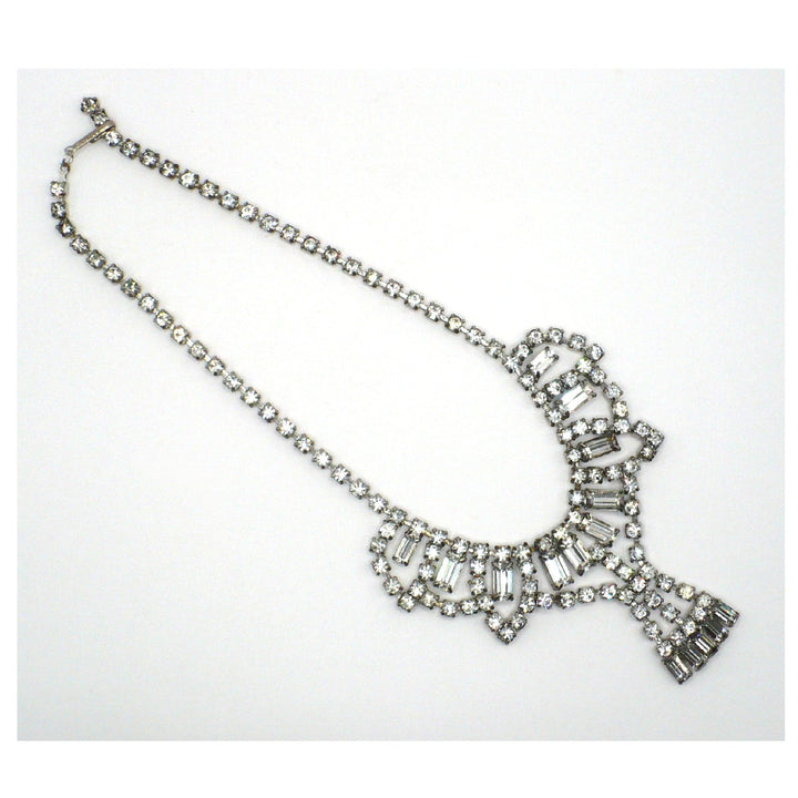 Signed Lisner 1950s vintage rhinestone festoon necklace laid flat, showing silver-tone crystal collar and mixed-cut stones.