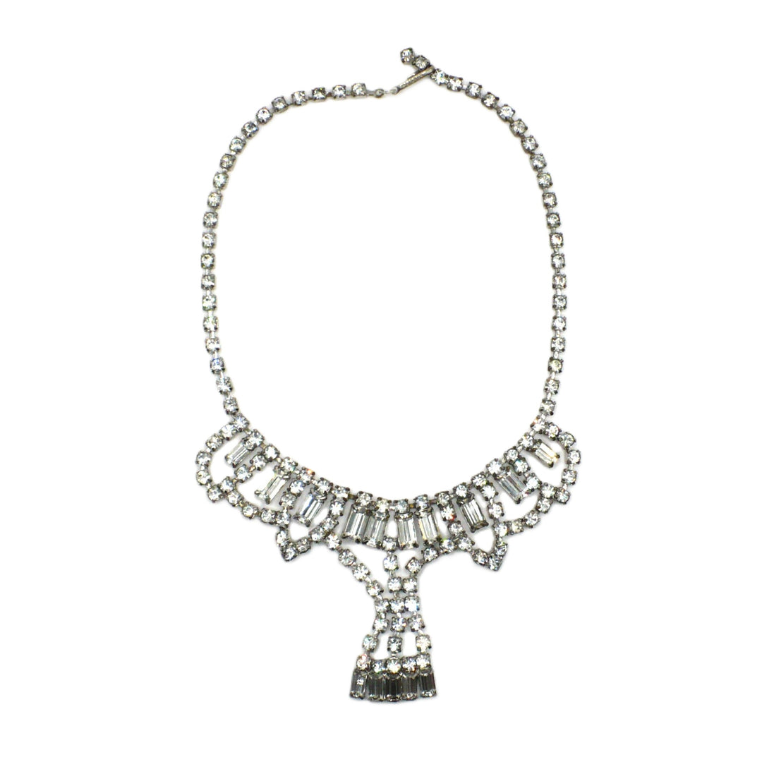 Signed vintage Lisner rhinestone festoon necklace layout showing the complete silver-tone crystal collar and draped centerpiece.