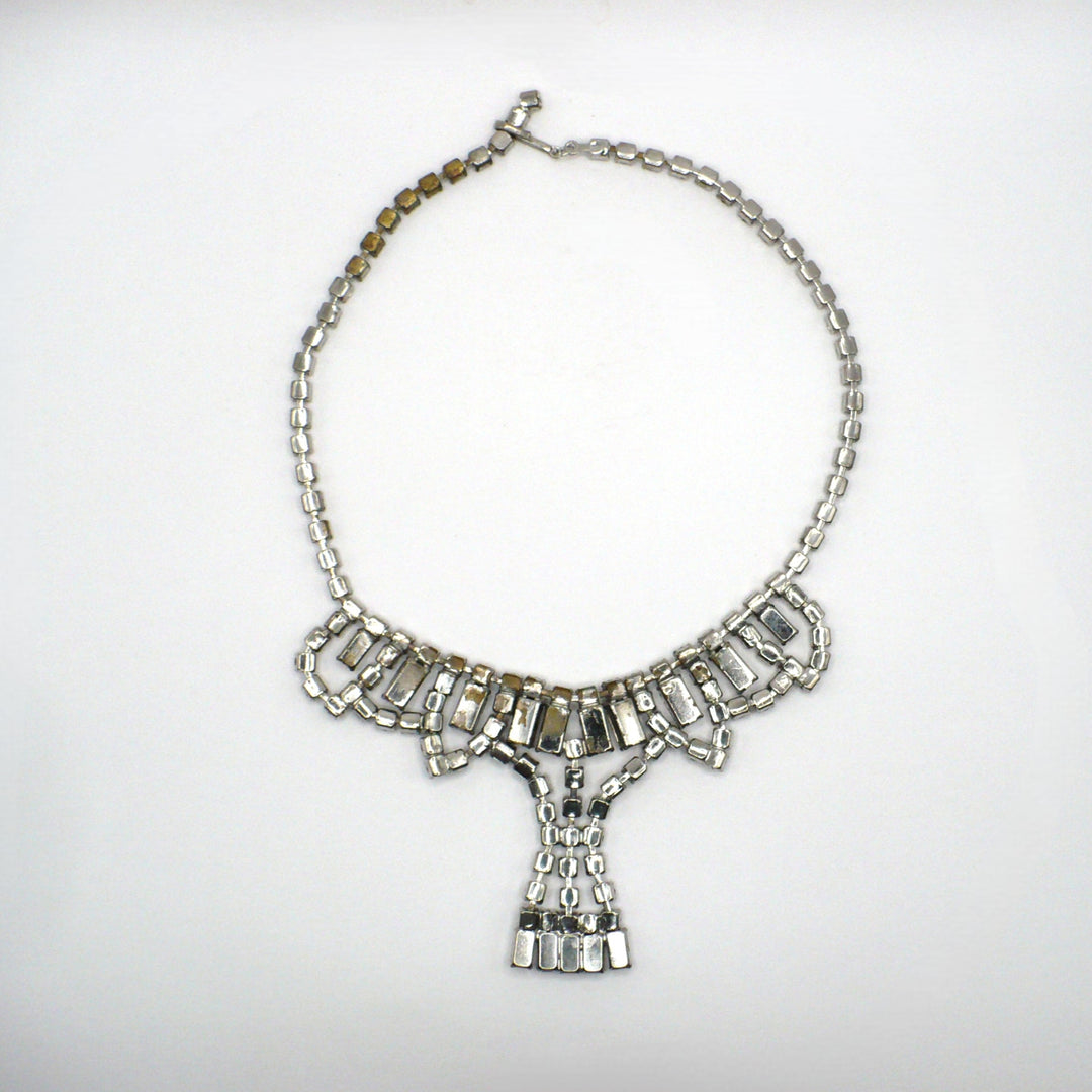 Signed vintage Lisner rhinestone festoon necklace back view showing construction details and minor wear to the silver-tone plating.