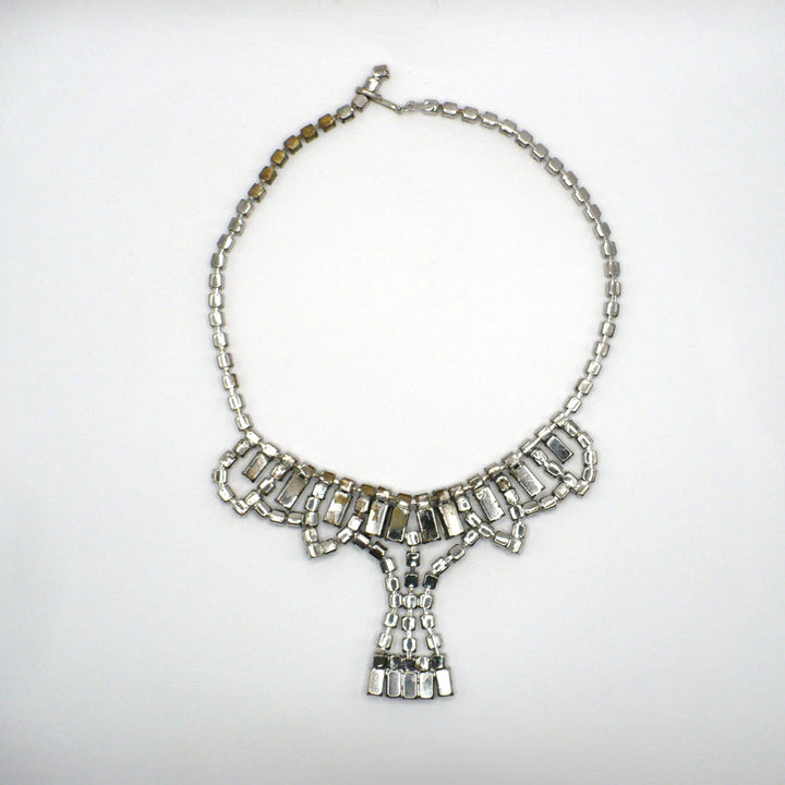Signed vintage Lisner rhinestone festoon necklace back view showing construction details and minor wear to the silver-tone plating.