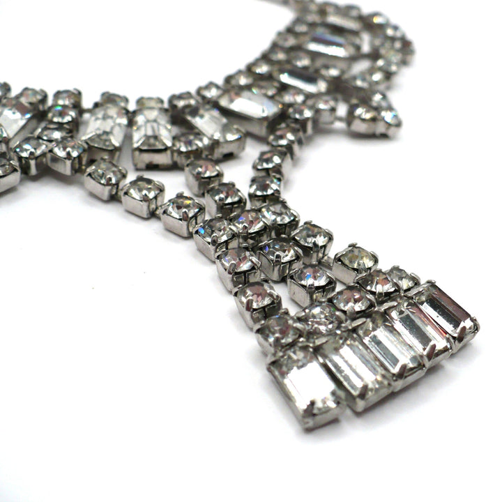 Signed vintage Lisner rhinestone festoon necklace close-up view highlighting layered rows and mixed-cut stones.