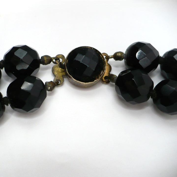 1950s vintage multi-strand black faceted glass bead necklace with a gold-toned ornamental box clasp