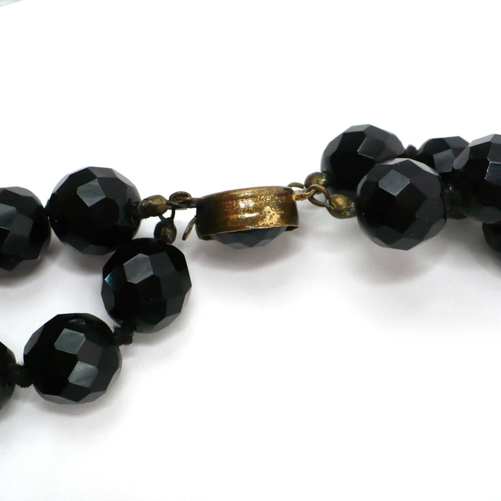 1950s vintage multi-strand black faceted glass bead necklace with a gold-toned ornamental box clasp side view.