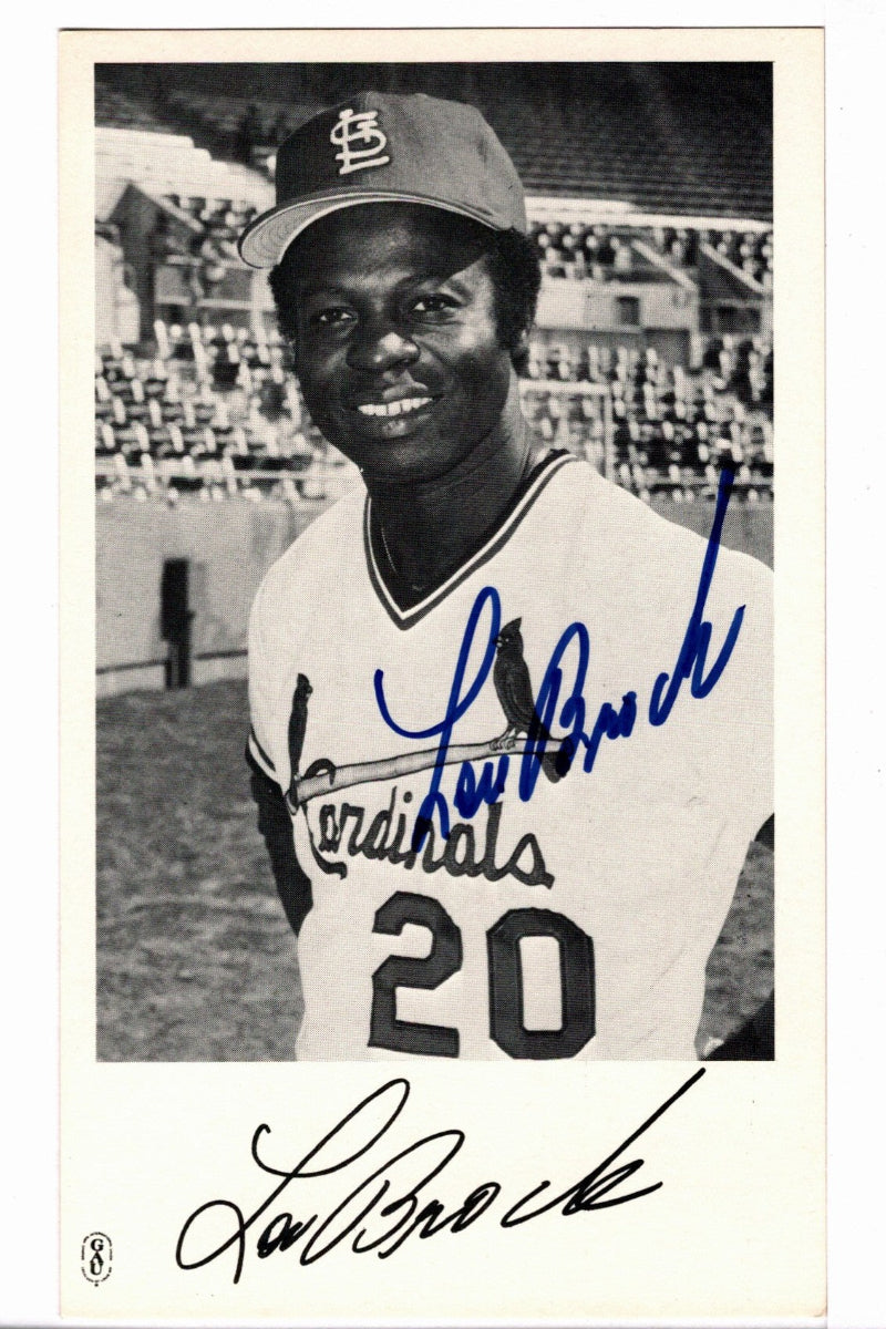 A vintage 1979 team-issued  black-and-white photograph featuring Lou Brock of the St. Louis Cardinals, signed in blue ink across the photo and with his signature printed at the bottom.
