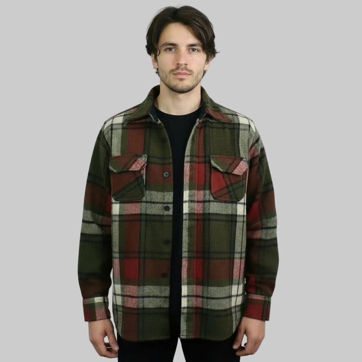 Man wearing a p1960s Vintage Shacket Plaid Wool Jacket on a gray background