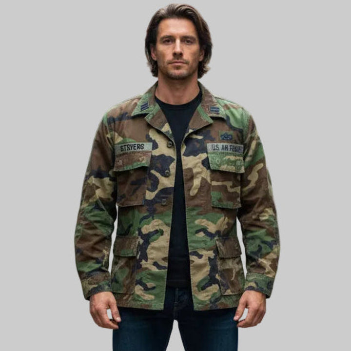 Man wearing a 1980 Vintage USAF BDU Woodland Camo Jacket Med/Short.