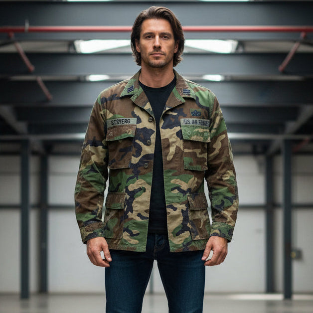 Man wearing a1980 Vintage USAF BDU Woodland Camo Jacket Med/Short  in an indoor setting.