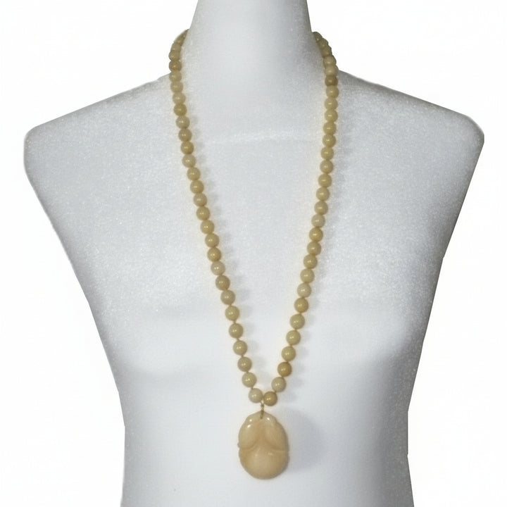 Post Mao Vintage Yellow Jade Necklace Hand-Carved Persimmon Pendant on dress form.
