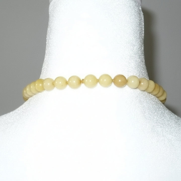 Post Mao Vintage Yellow Jade Necklace Hand-Carved Persimmon Pendant on dress form shows no clasp, but beads all the way around, slip on.