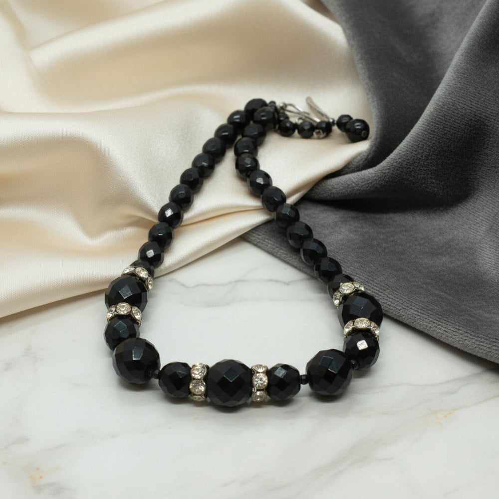 1950s Vintage Black Czech Glass Bead Cocktail Choker Necklace  on fabric.