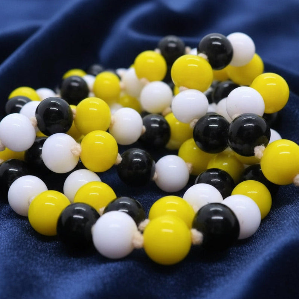 1920s Vintage Long  Glass Beaded Lampwork Flapper Necklace on blue backgound.