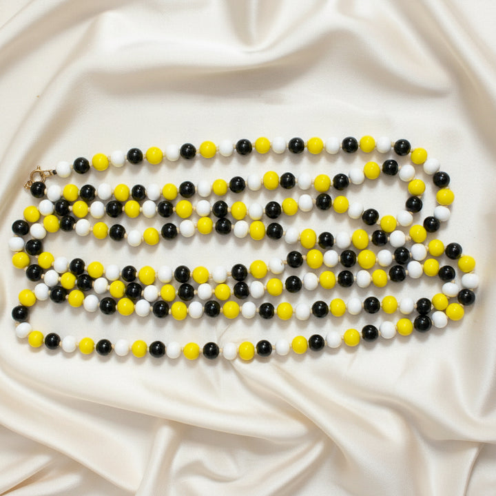 1920s Vintage Long  Glass Beaded Lampwork Flapper Necklace. on cream fabric.