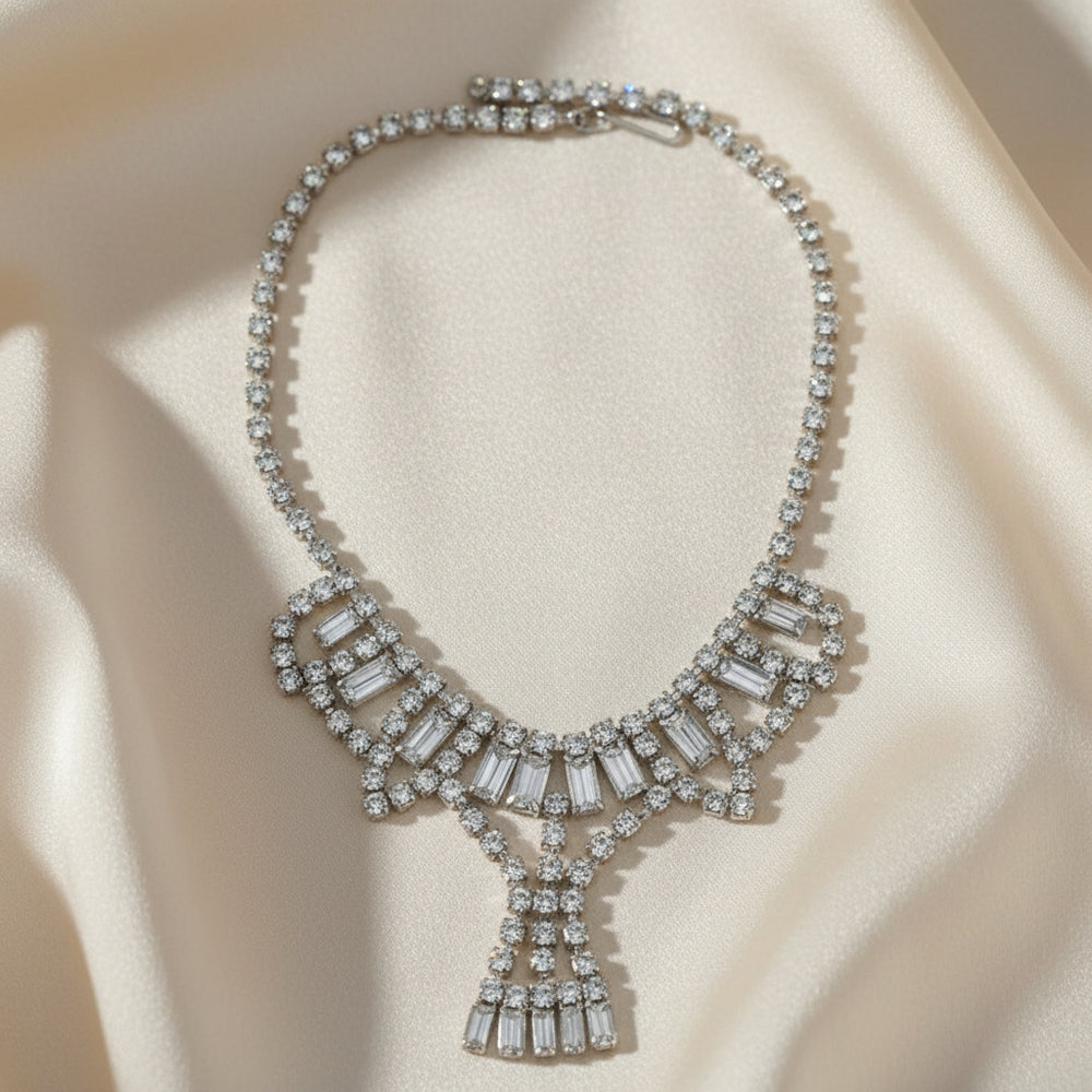 1950s Vintage Art Deco Rhinestone Festoon Necklace front view on creamy silk fabric.