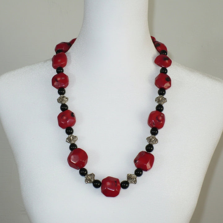1970s Vintage Red Bamboo Coral Nugget, Black Onyx, and silver Bead Necklace on dress form.