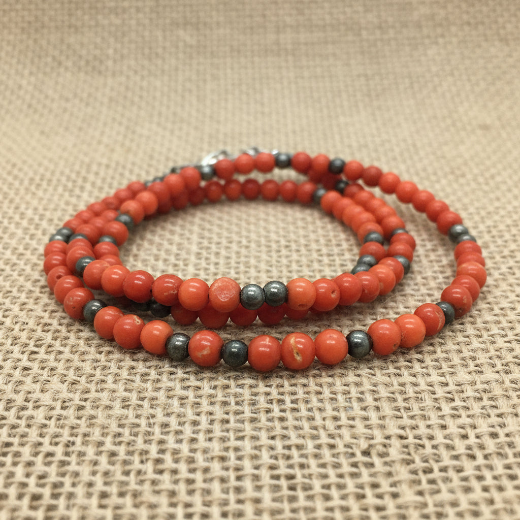 1970s Coral & Hematite Boho Beaded Necklace. on burlap fabric.