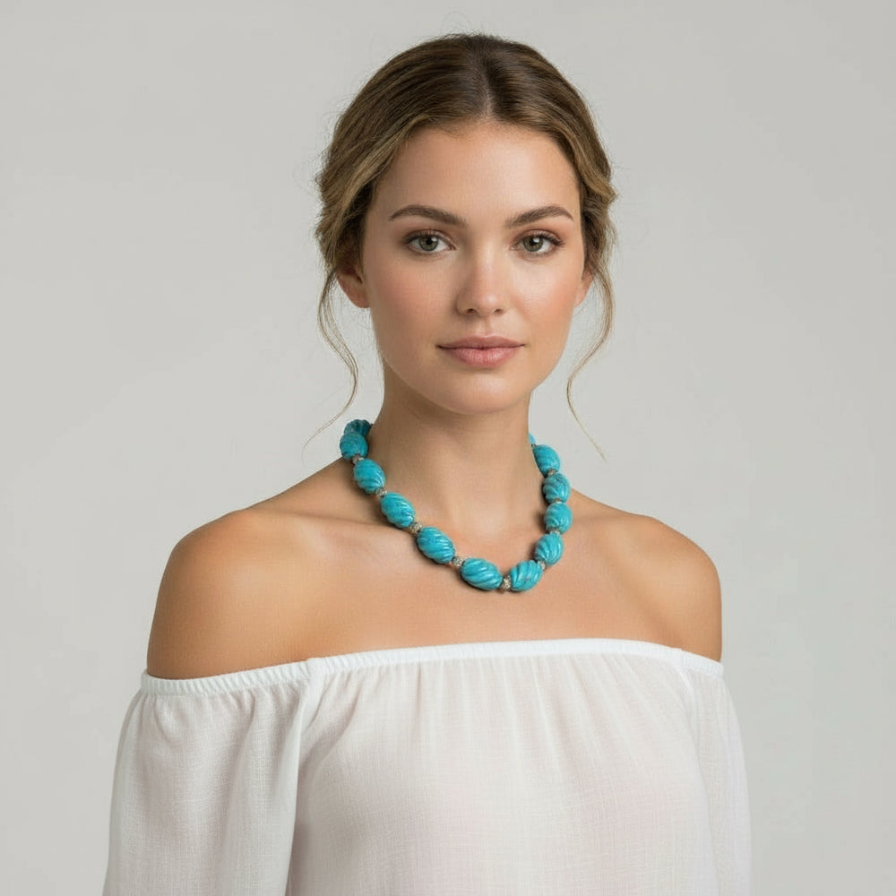 Woman wearing a turquoise 1970s Vintage Blue Howlite and silver beaded Necklace.