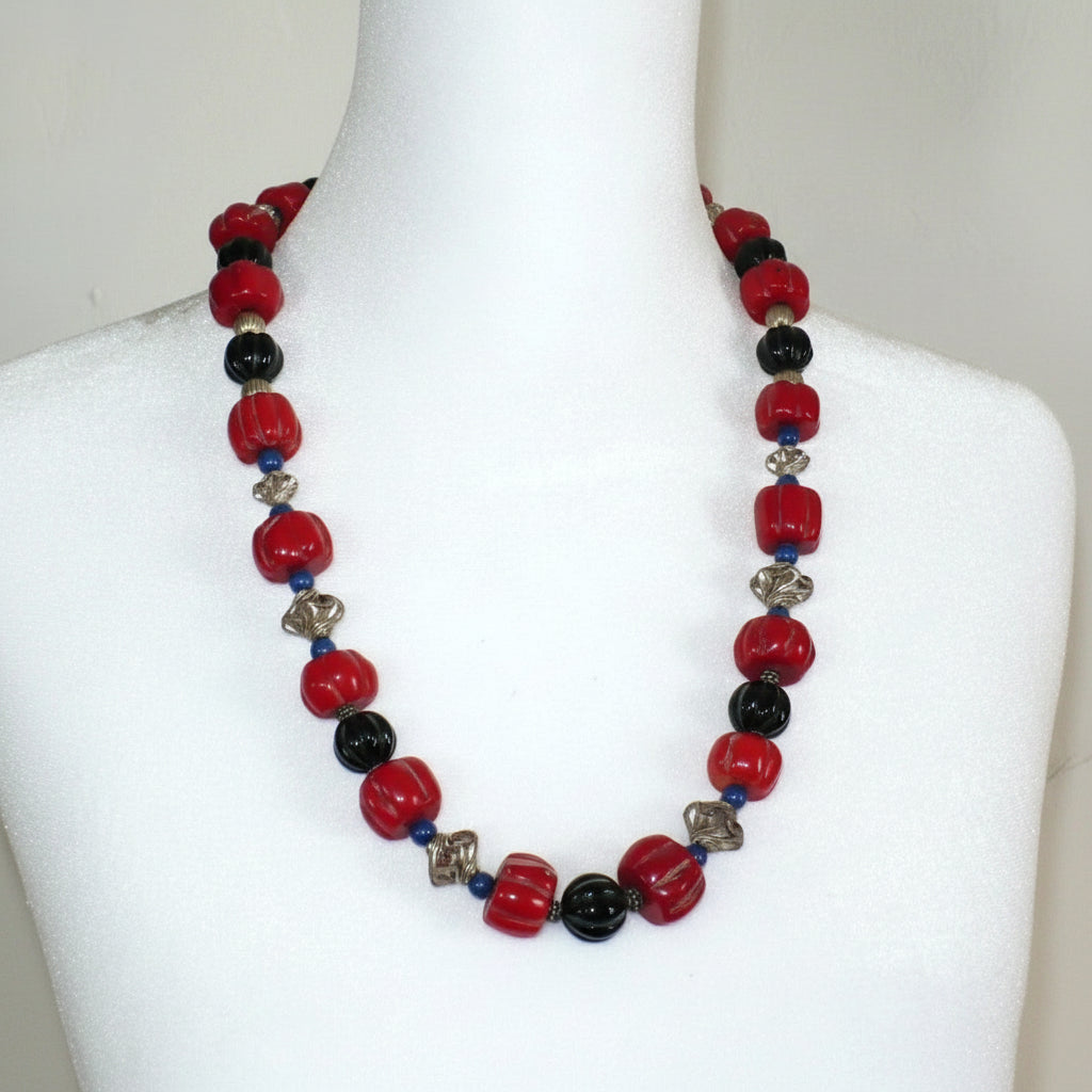 1970 Vintage Red Bamboo Coral, Onyx & Lapis Lazuli Beaded Necklace on a dress form.