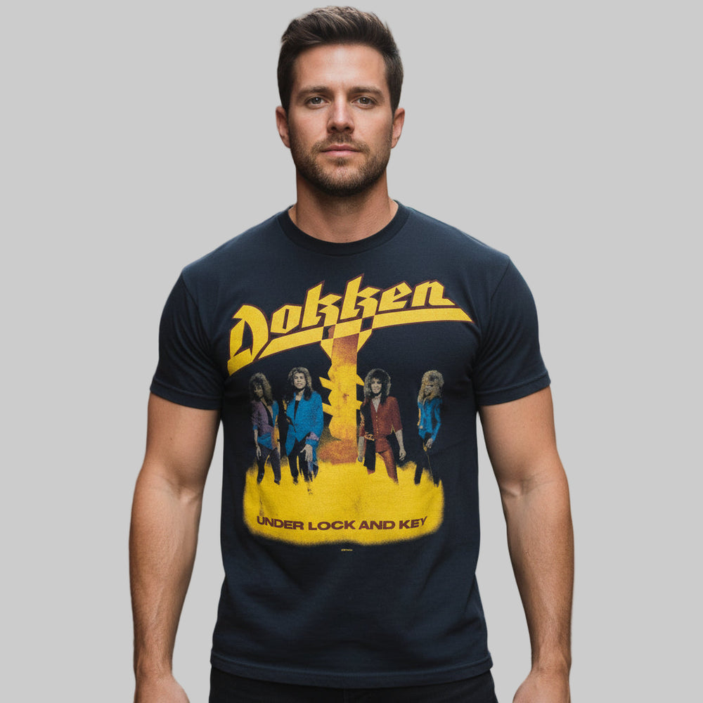 1985/1986 Blue Vintage Dokken Under Lock and Key Band T-Shirt on man, plain background.