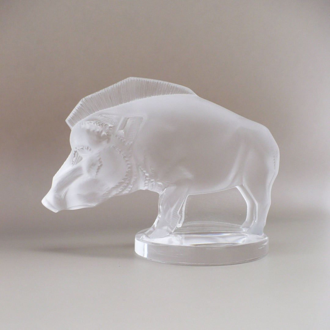 A frosted glass sculpture of Lalique Sanglier Bouchon de Radiateur: Wild Boar Car Mascot, left side view.