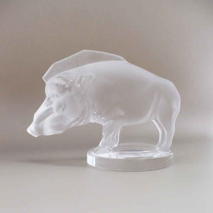 A frosted glass sculpture of Lalique Sanglier Bouchon de Radiateur: Wild Boar Car Mascot, left side view.
