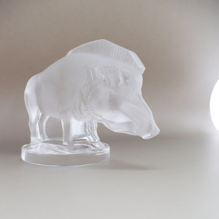 A frosted glass sculpture of Lalique Sanglier Bouchon de Radiateur: Wild Boar Car Mascot, 3/4 angled view.
