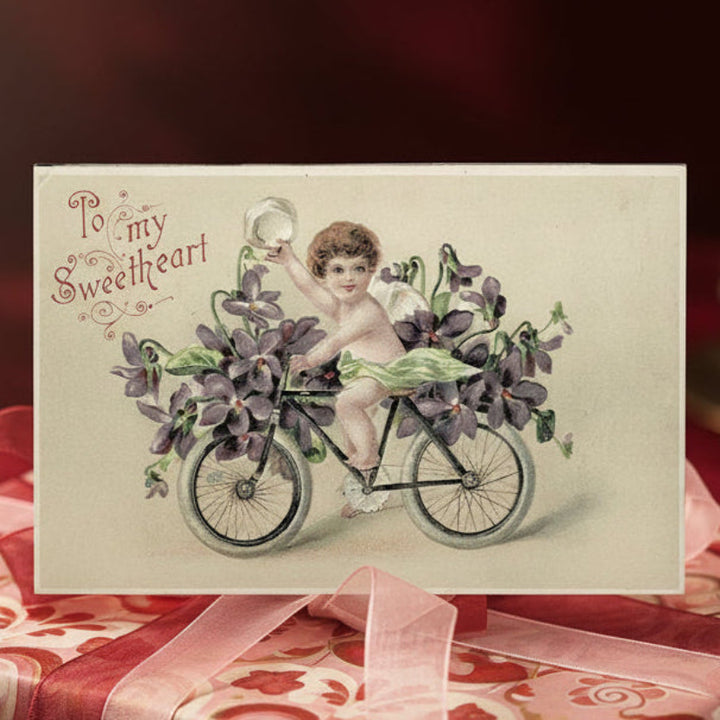 1908 Cupid Delivers Flowers Bicycle Antique Vintage Valentine Postcard.