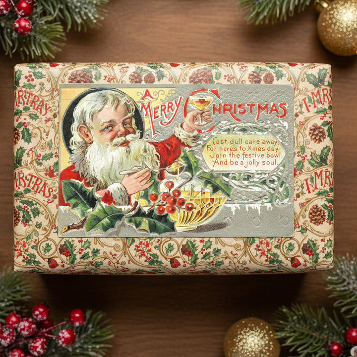 Vintage-style Christmas gift box with 1910 Santa Makes A Christmas Toast A Festive Vintage Holiday Postcard on a wooden surface with festive decorations.