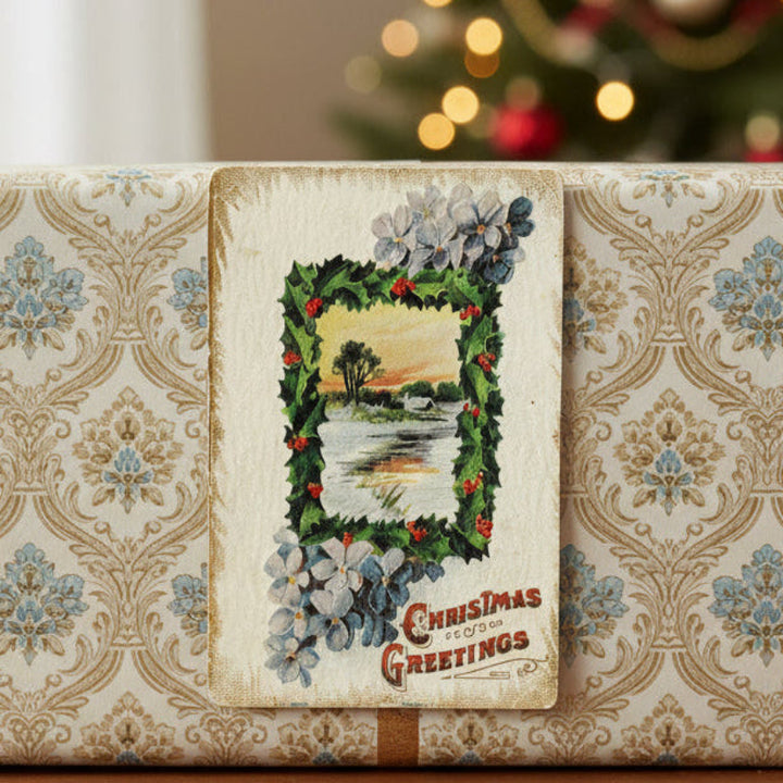 Decorative Christmas box with 1909 Forget-me-not Wintery Pastoral Antique Vintage Christmas Postcard and Christmas tree in the background