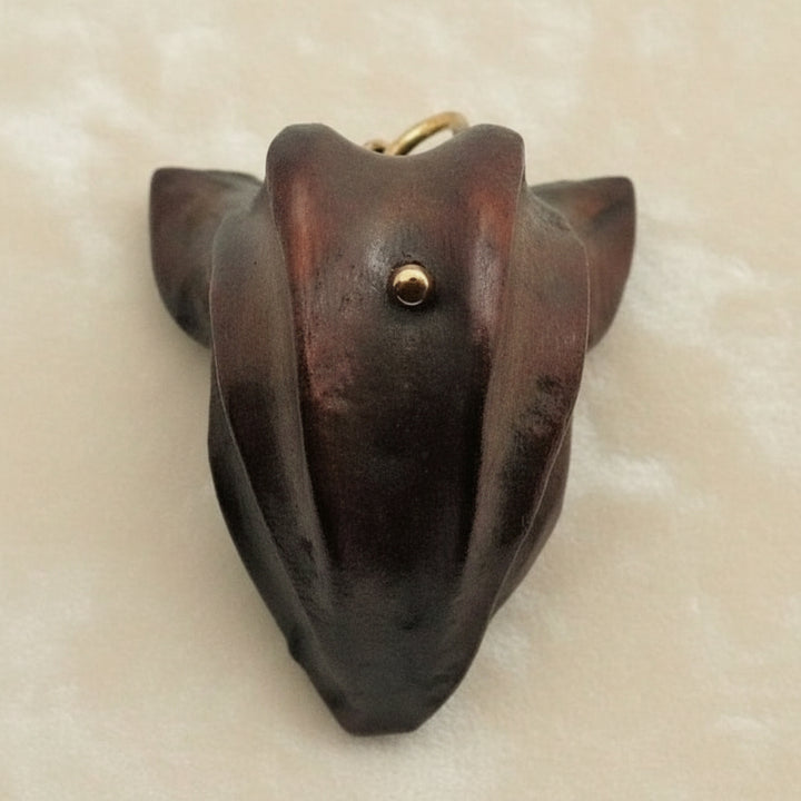 1960 Vintage Samurai Oni Hannya Mask Warthog Pendant with velvet background.