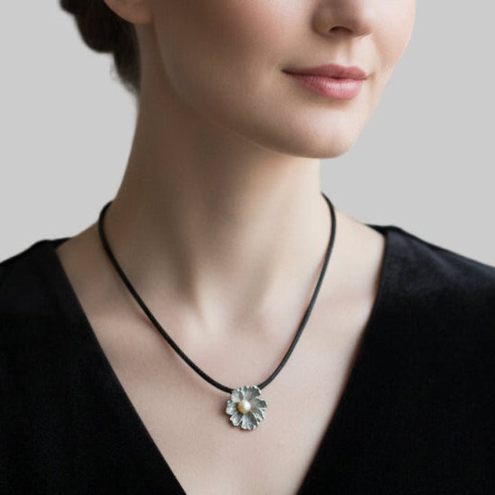 Woman wearing Silver Flower and Pearl Pendant.