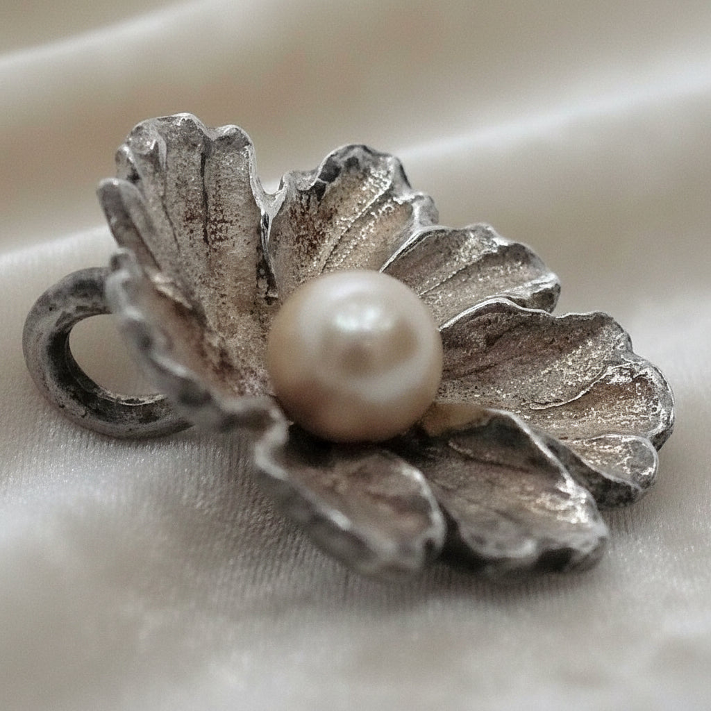 Silver Flower and Pearl Pendant on velvet ground.