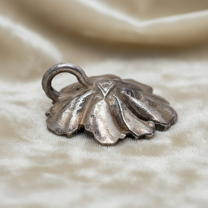 Silver Flower and Pearl Pendant on velvet ground.