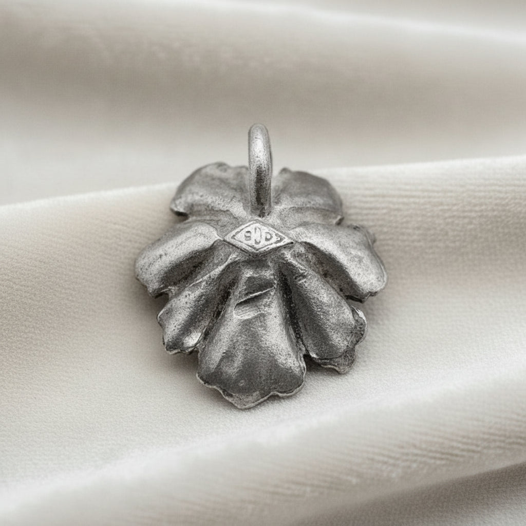 Silver Flower and Pearl Pendant on velvet ground.