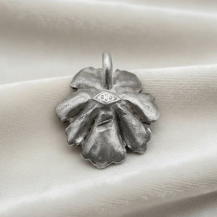 Silver Flower and Pearl Pendant on velvet ground.
