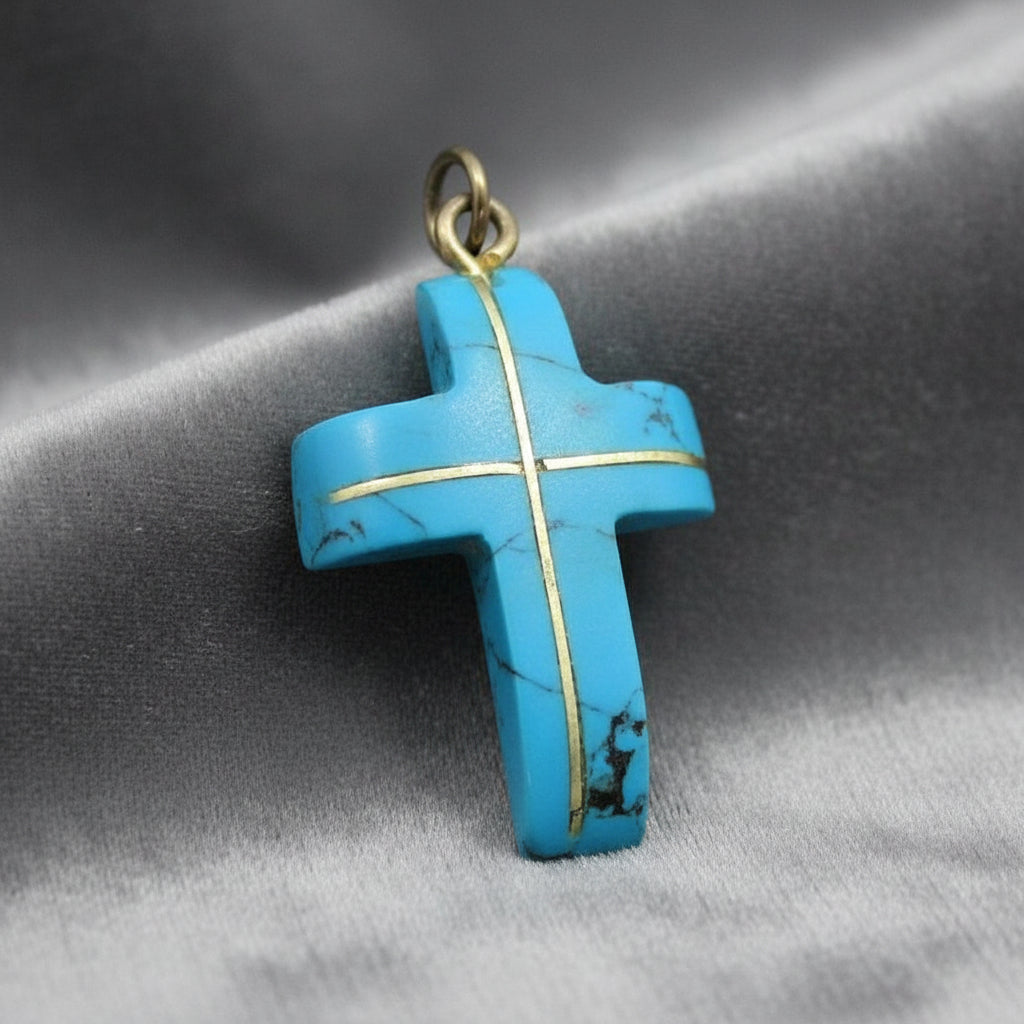 Blue Howlite cross pendant on gray background.