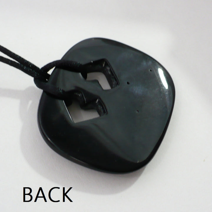 Back of vintage black ceramic endless knot pendant.