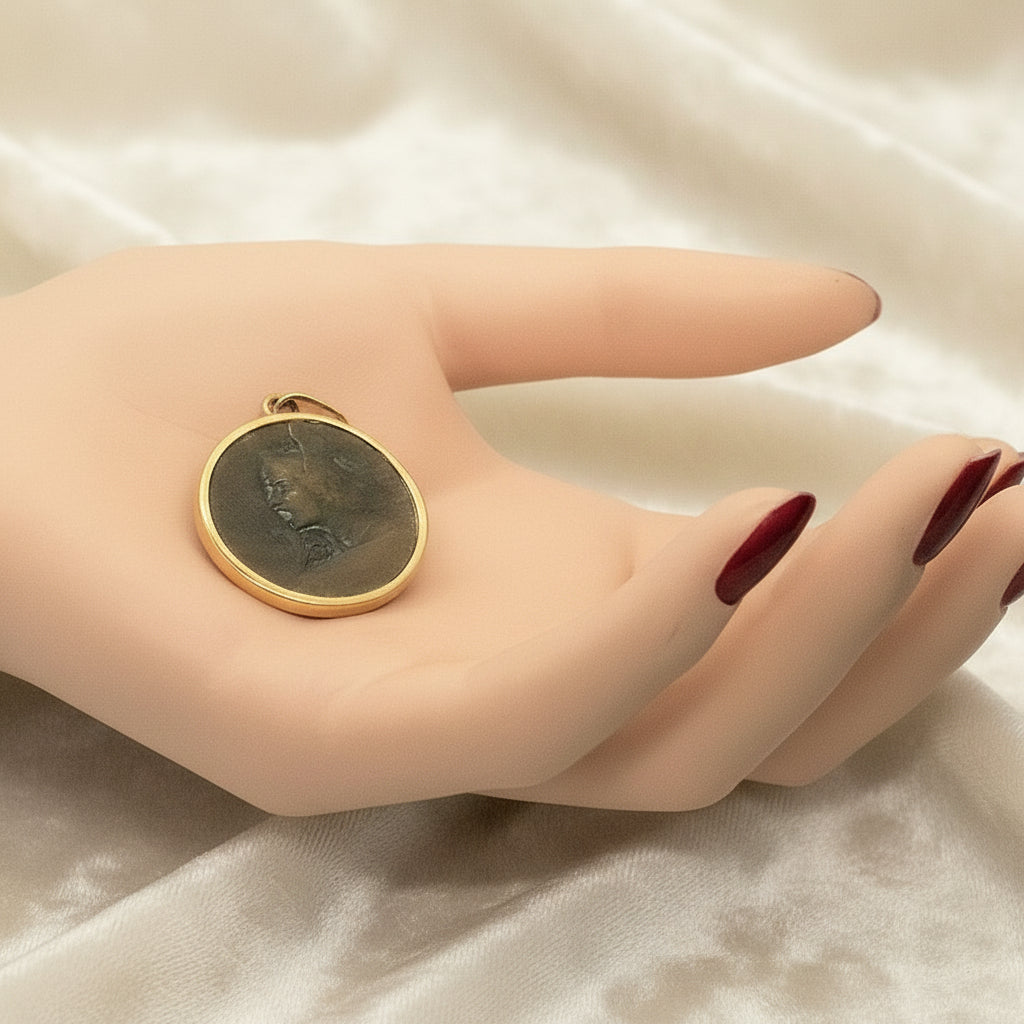 Perseus Pendant in Bronze & 24k Gold in mannequin hand.