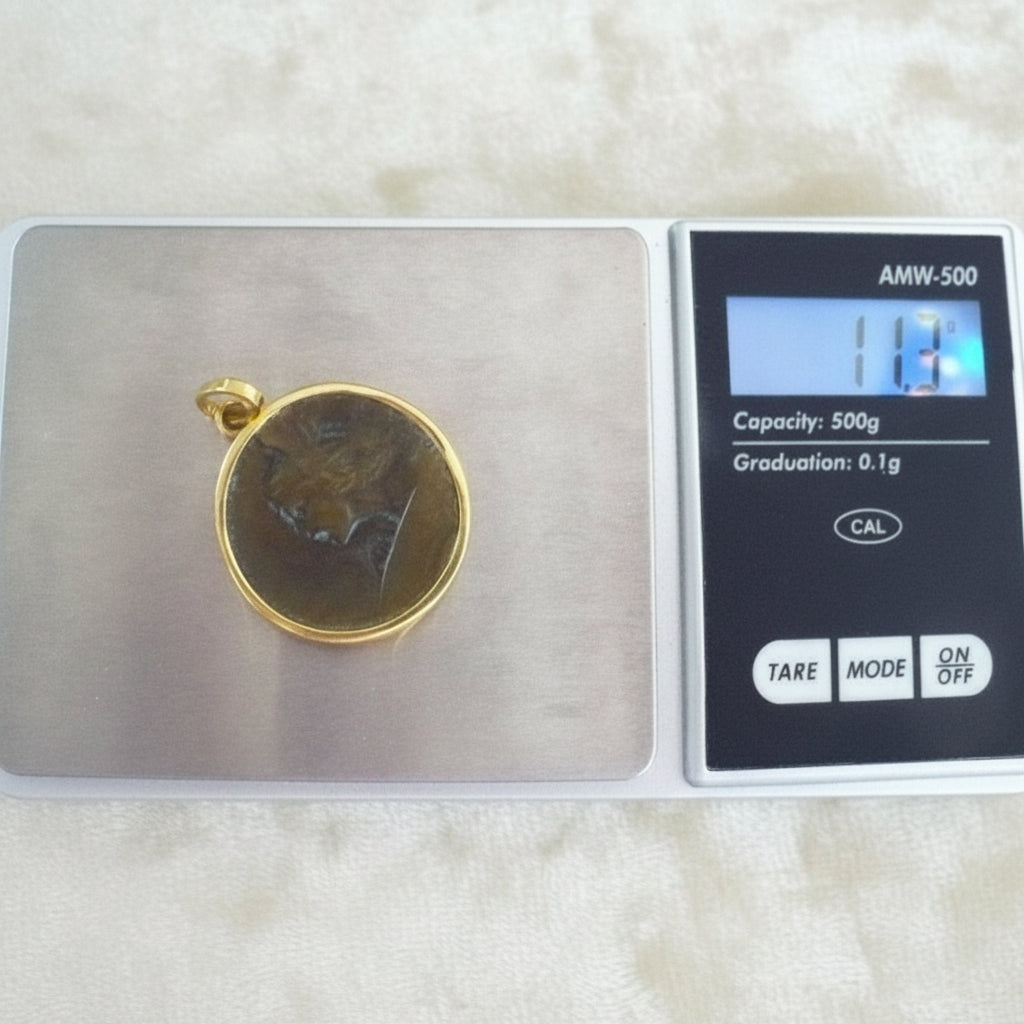 Perseus Pendant in Bronze & 24k Gold on jewelry scale.